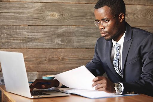 Attorney reviewing web design elements on a laptop for law firm website development