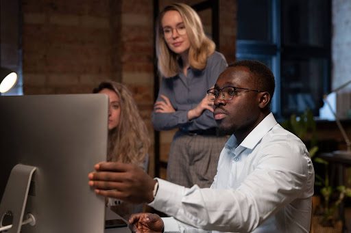 Focused professionals discussing web design for a family lawyer's website.