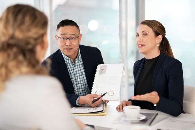 Two professionals discussing a document, symbolizing effective immigration case management.