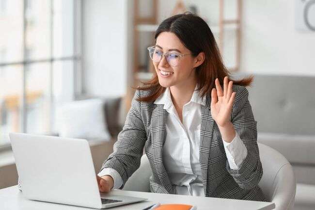 Businesswoman on a video call, demonstrating remote collaboration in immigration case management.