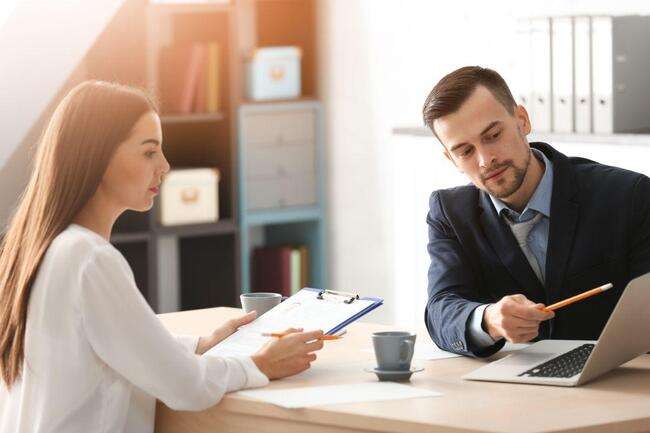 Business meeting between a man and a woman with a laptop