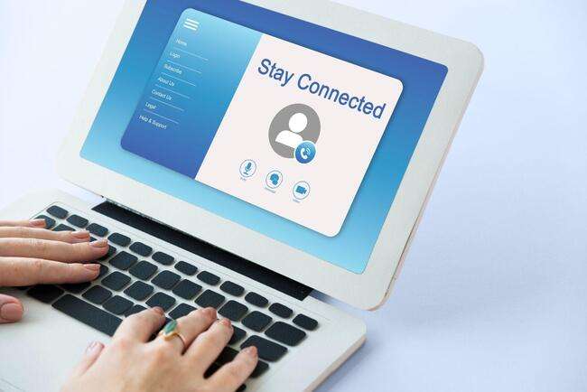"Hands typing on a laptop with a screen displaying 'Stay Connected'